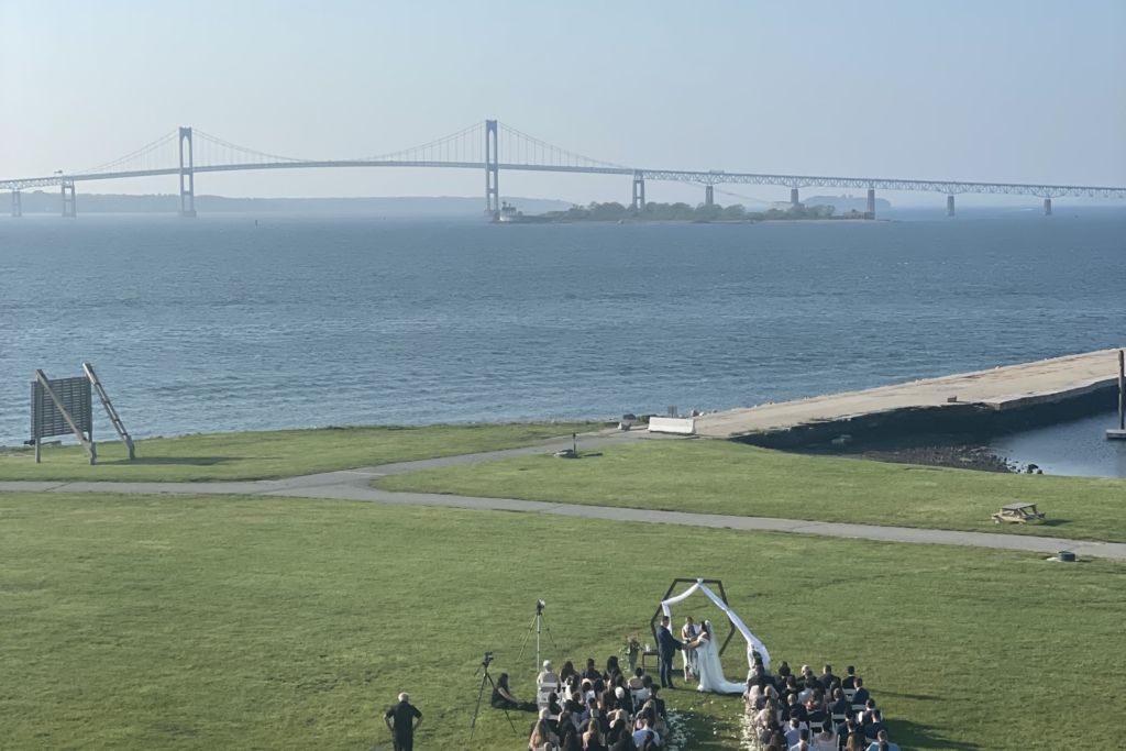 A waterfront wedding ceremony on the North Lawn with the Newport Pell Bridge beyond